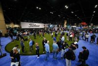 Guests on the Titleist putting green activation during the PGA Show