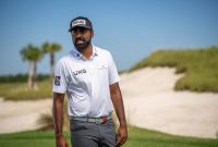 pro golfer Sahith Theegala walking on a golf course