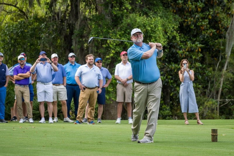 Beau Welling hitting a golf ball as the Ceremonial First Tee Shot on Oak Marsh Golf Course.