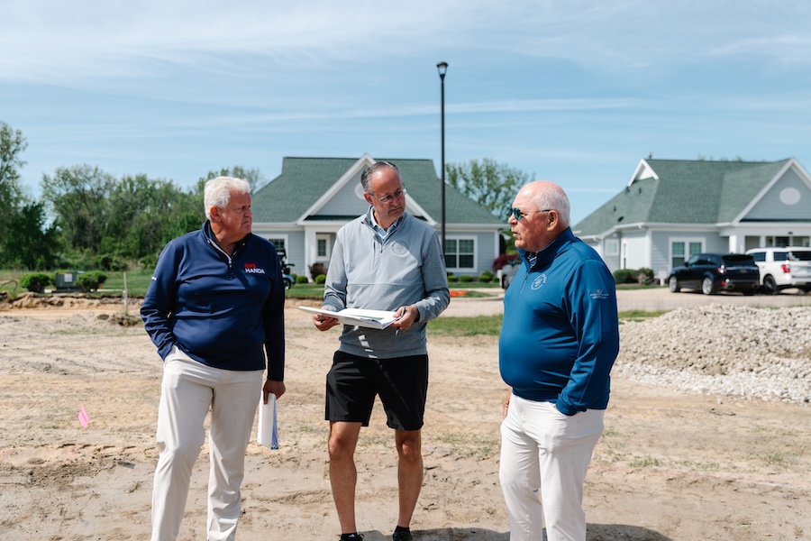 Colin Montgomerie, Chris Cook and Jeff Fettig on golf course work site.
